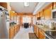 Kitchen with wood cabinets, granite countertops and tile floors at 9267 Sw 91St Cir, Ocala, FL 34481