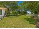 Landscaped backyard with lush greenery and pathway at 10557 Sw 62Nd Ct, Ocala, FL 34476