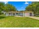 Ranch-style home with a carport and well-manicured lawn at 10557 Sw 62Nd Ct, Ocala, FL 34476