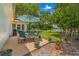 Relaxing patio area with seating and umbrella, overlooking the yard at 10557 Sw 62Nd Ct, Ocala, FL 34476