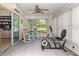 Sunroom features sliding doors, ceiling fan, and exercise bike at 10557 Sw 62Nd Ct, Ocala, FL 34476