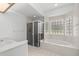 Bathroom with soaking tub, shower, and large window at 11462 Sw 82Nd Court Rd, Ocala, FL 34481