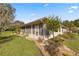 Side view of house showing screened-in patio and landscaping at 11462 Sw 82Nd Court Rd, Ocala, FL 34481