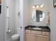 Small half bathroom with a vanity and round mirror at 12330 Nw 35Th St, Ocala, FL 34482