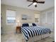 Bedroom with a striped comforter and a coastal vibe at 12330 Nw 35Th St, Ocala, FL 34482