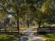 Long driveway leading to a home with lush landscaping and trees at 12330 Nw 35Th St, Ocala, FL 34482