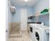 Laundry room with washer, dryer, and built in shelving at 12330 Nw 35Th St, Ocala, FL 34482