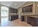 Spacious kitchen featuring dark wood cabinets and granite countertops at 14269 Se 27Th Ct, Summerfield, FL 34491