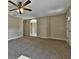 Spacious living room with neutral carpeting and ceiling fan at 14269 Se 27Th Ct, Summerfield, FL 34491