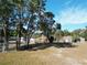 Large backyard with trees and a dog kennel at 14320 Se 96Th Ct, Summerfield, FL 34491