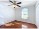 Bedroom with hardwood floors, ceiling fan, and double door closet at 14320 Se 96Th Ct, Summerfield, FL 34491