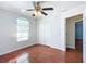 Bedroom with hardwood floors, ceiling fan, and double door closet at 14320 Se 96Th Ct, Summerfield, FL 34491