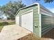 Green metal double-car garage with white doors at 14320 Se 96Th Ct, Summerfield, FL 34491