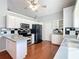 Kitchen with white cabinets, stainless steel appliances, and hardwood floors at 14320 Se 96Th Ct, Summerfield, FL 34491