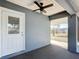 Cozy screened porch with door and ceiling fan at 14320 Se 96Th Ct, Summerfield, FL 34491