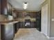 Dark wood cabinets and black appliances in kitchen at 14448 Sw 75 Cir, Ocala, FL 34473