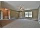 Spacious living room with ceiling fan and carpet at 14448 Sw 75 Cir, Ocala, FL 34473