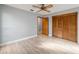 Bright bedroom with wood-look floors and double doors leading to a large closet at 15154 Sw 38Th Cir, Ocala, FL 34473