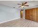 Bedroom with wood-paneled closet and ceiling fan at 15154 Sw 38Th Cir, Ocala, FL 34473