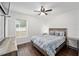 Cozy bedroom with queen bed, window, and ceiling fan at 16050 Sw 35Th Court Rd, Ocala, FL 34473