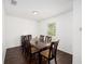 Bright dining room with dark wood table and six chairs at 16050 Sw 35Th Court Rd, Ocala, FL 34473