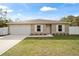 Newly built home with a fenced yard and a concrete driveway at 16050 Sw 35Th Court Rd, Ocala, FL 34473