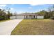 Newly built home with a fenced yard and a concrete driveway at 16050 Sw 35Th Court Rd, Ocala, FL 34473