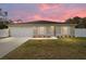 House exterior at sunset with landscaped yard at 16050 Sw 35Th Court Rd, Ocala, FL 34473