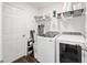 Bright laundry room with washer, dryer, and ample shelving at 16050 Sw 35Th Court Rd, Ocala, FL 34473