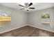 Bright bedroom with wood-look floors and two windows at 16689 Sw 22Nd Terrace Rd, Ocala, FL 34473