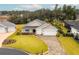 Aerial view of a house, two-car garage, and landscaped yard at 17920 Sw 66Th Pl, Dunnellon, FL 34432