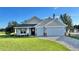 Newly constructed home with two-car garage and manicured lawn at 17920 Sw 66Th Pl, Dunnellon, FL 34432