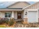 Inviting home exterior featuring a front porch and landscaping at 17920 Sw 66Th Pl, Dunnellon, FL 34432