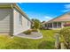 Landscaped backyard with a manicured lawn and flower bed at 1918 Walden Way, The Villages, FL 32162