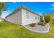 Landscaped backyard with a manicured lawn and flower bed at 1918 Walden Way, The Villages, FL 32162