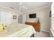 Spacious bedroom with a dresser and large TV at 1918 Walden Way, The Villages, FL 32162