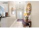 Inviting entryway with tiled floor and decorative mirror at 1918 Walden Way, The Villages, FL 32162