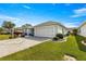 Single-story home with paved driveway and landscaped yard at 1918 Walden Way, The Villages, FL 32162