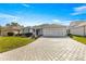 Single-story home with paved driveway and landscaped yard at 1918 Walden Way, The Villages, FL 32162