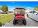 Red and white Club Car golf cart with accessories at 1918 Walden Way, The Villages, FL 32162