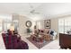 Comfortable living room with vaulted ceiling and hardwood floors at 1918 Walden Way, The Villages, FL 32162