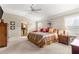 Bright main bedroom with a king-size bed and wood furnishings at 1918 Walden Way, The Villages, FL 32162