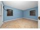 Simple bedroom with light blue walls and wood-look flooring at 1981 Se 54Th Ter, Ocala, FL 34480