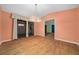 Dining room with light peach walls, wood-look flooring, and sliding glass doors at 1981 Se 54Th Ter, Ocala, FL 34480