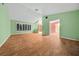 Large living room featuring wood-look flooring and a view into dining area at 1981 Se 54Th Ter, Ocala, FL 34480