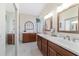 Elegant bathroom with dual vanity and large mirrors at 2111 Nw 58Th Ct, Ocala, FL 34482