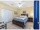 Guest bedroom with a wooden bed frame and built-in drawers at 2111 Nw 58Th Ct, Ocala, FL 34482