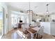 Bright dining room with wooden table, chairs, and a view of the kitchen at 2111 Nw 58Th Ct, Ocala, FL 34482