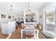 Dining area with table and chairs, kitchen island, and living room view at 2111 Nw 58Th Ct, Ocala, FL 34482