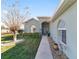 House entrance with a covered walkway, landscaping and architectural details at 2111 Nw 58Th Ct, Ocala, FL 34482